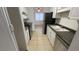 Bright kitchen featuring tile floors, stainless steel appliances, and ample white cabinet space at 7502 Needle Leaf Pl # B66, Tampa, FL 33617