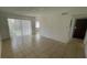 Spacious living room with tile flooring, large windows, and a sliding glass door at 7502 Needle Leaf Pl # B66, Tampa, FL 33617