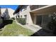 Outdoor patio area with access to the building and small yard at 7502 Needle Leaf Pl # B66, Tampa, FL 33617
