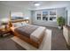Comfortable bedroom with a wooden bed frame, soft rug, neutral color palette, and lots of natural light at 6525 Dutton Dr, Wesley Chapel, FL 33545