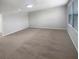 A spacious bedroom with neutral walls, carpeting, and bright natural light from the windows at 6525 Dutton Dr, Wesley Chapel, FL 33545