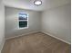 Vacant bedroom with neutral walls, plush carpeting, and a bright window at 6525 Dutton Dr, Wesley Chapel, FL 33545