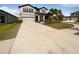 Charming two-story home with a well-manicured front lawn and a spacious driveway leading to a two-car garage at 6525 Dutton Dr, Wesley Chapel, FL 33545