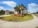 Inviting home exterior featuring lush landscaping and a welcoming entrance, perfect for a serene neighborhood setting at 6525 Dutton Dr, Wesley Chapel, FL 33545