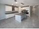 Bright kitchen features white cabinets, granite countertops, stainless steel appliances, and a large island at 6525 Dutton Dr, Wesley Chapel, FL 33545