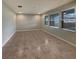 Spacious room with tile flooring and multiple large windows allowing for ample natural light, creating a bright ambiance at 6525 Dutton Dr, Wesley Chapel, FL 33545