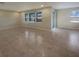 Open living space with tile flooring and an abundance of natural light from multiple windows at 6525 Dutton Dr, Wesley Chapel, FL 33545