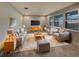 Bright living room with gray sofas, matching chairs, a patterned rug, and a large window at 6525 Dutton Dr, Wesley Chapel, FL 33545