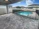 Backyard featuring a sparkling pool enclosed with a safety fence and a paved patio area for outdoor enjoyment at 6525 Dutton Dr, Wesley Chapel, FL 33545