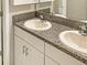 Bathroom vanity with dual sinks and granite countertop at 13507 Willow Bluestar Loop, Riverview, FL 33579