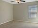 Neutral bedroom with wall to wall carpeting, a window, and a ceiling fan at 13507 Willow Bluestar Loop, Riverview, FL 33579