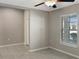 Bedroom with a ceiling fan and a large window at 13507 Willow Bluestar Loop, Riverview, FL 33579