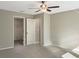 Neutral bedroom with a walk-in closet, ceiling fan and plush carpet at 13507 Willow Bluestar Loop, Riverview, FL 33579