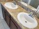 Bathroom featuring double sinks with stylish dark wood cabinetry and fixtures at 2313 Richwood Pike Dr, Ruskin, FL 33570