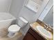 Bathroom featuring a sink with wood cabinetry, toilet, and tub at 2313 Richwood Pike Dr, Ruskin, FL 33570