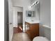 Bathroom featuring a wood vanity with a light countertop, and a large mirror at 3328 Circleville St, North Port, FL 34286