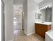 Bathroom featuring a wood vanity with a light countertop, and access to the rest of the home at 3328 Circleville St, North Port, FL 34286