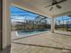 Screened lanai featuring a pool, large pavers, and a ceiling fan, offering a great outdoor living and entertaining space at 3328 Circleville St, North Port, FL 34286