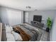 Serene bedroom featuring neutral decor, a large closet, and a sleek media console with modern accents at 5125 Janice Ln, Holiday, FL 34690