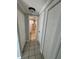 Hallway leading to a bathroom, with three closets at 5125 Janice Ln, Holiday, FL 34690