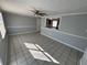 Bright, open living room featuring neutral walls, tile flooring, and a ceiling fan at 5125 Janice Ln, Holiday, FL 34690