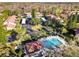 A beautiful aerial view of the community pool and clubhouse surrounded by lush landscaping and mature trees at 1801 E Lake Rd # 3A, Palm Harbor, FL 34685