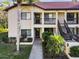 Charming condo featuring tropical landscaping and an inviting entryway at 1801 E Lake Rd # 3A, Palm Harbor, FL 34685