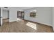 Bright room with wood-look flooring and a sliding glass door to an enclosed porch at 4522 Marine Pkwy, New Port Richey, FL 34652
