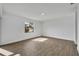 Spacious room featuring a large window, wood-look flooring, white walls, and recessed lighting at 4522 Marine Pkwy, New Port Richey, FL 34652