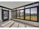Enclosed porch featuring large windows overlooking the backyard, with durable flooring and ceiling fan at 4522 Marine Pkwy, New Port Richey, FL 34652