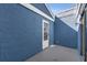 A beautiful blue exterior wall and white door make this a charming outdoor space at 4522 Marine Pkwy, New Port Richey, FL 34652