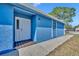 Eye-catching home featuring a bright blue exterior and a charming white front door at 4522 Marine Pkwy, New Port Richey, FL 34652