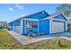 Charming blue home featuring a well-kept lawn and a two-car garage at 4522 Marine Pkwy, New Port Richey, FL 34652