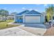 Exterior view of the home with a two-car garage and a well-manicured lawn at 4522 Marine Pkwy, New Port Richey, FL 34652