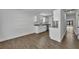 Bright kitchen featuring modern cabinets, granite countertops, stainless steel appliances, and wood-look floors at 4522 Marine Pkwy, New Port Richey, FL 34652