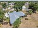 An aerial view showcasing the home's roof, lush surroundings and its position among neighboring residences at 26058 Paysandu Dr, Punta Gorda, FL 33983