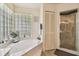 Bathroom featuring a bathtub with privacy window and a separate shower at 26058 Paysandu Dr, Punta Gorda, FL 33983