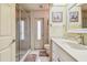Bright bathroom features a glass shower, a large white vanity, and marble tile floor at 26058 Paysandu Dr, Punta Gorda, FL 33983
