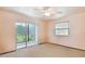 Bright bedroom featuring a sliding glass door leading to a private balcony with natural light at 26058 Paysandu Dr, Punta Gorda, FL 33983