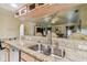 Kitchen with stainless steel double sink and granite countertops at 26058 Paysandu Dr, Punta Gorda, FL 33983