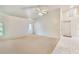 A large living room featuring carpet flooring and two windows with an exterior door at 26058 Paysandu Dr, Punta Gorda, FL 33983