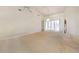 Expansive living room featuring plush neutral carpet, high ceilings, and a chandelier at 26058 Paysandu Dr, Punta Gorda, FL 33983