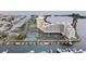 Elevated aerial view of waterfront condo complex with tennis courts and private docks at 5915 Sea Ranch Dr # 412, Hudson, FL 34667