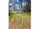 View of a shaded backyard structure surrounded by lush greenery, providing a tranquil retreat at 9151 Bay Dr, Spring Hill, FL 34606