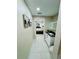 Hallway leading to a bedroom and a bathroom with modern fixtures and tile flooring at 9151 Bay Dr, Spring Hill, FL 34606