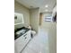 Bathroom featuring a modern vanity, toilet, and bathtub at 9151 Bay Dr, Spring Hill, FL 34606
