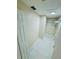 Walk-in closet with built-in shelving and white tile floors, offering ample storage at 9151 Bay Dr, Spring Hill, FL 34606