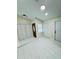 Bright entryway with white tile flooring and storage closets at 9151 Bay Dr, Spring Hill, FL 34606