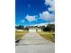 Charming single-story home featuring a two-car garage and a lush green lawn under a beautiful blue sky at 9151 Bay Dr, Spring Hill, FL 34606