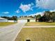 Well-maintained single-story home featuring a long driveway, two-car garage and lush green lawn at 9151 Bay Dr, Spring Hill, FL 34606